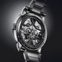 A close-up of the Arnold & Son Nebula 41.5 Steel luxury skeleton watch highlights its visible gears and intricate mechanical details.