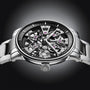 The Arnold & Son Nebula 41.5 Steel is a luxury skeleton watch with exposed gears and mechanisms, featuring a stainless steel bracelet and black accents.