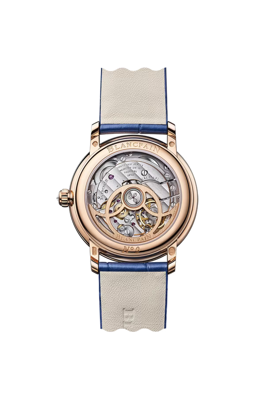 Rose gold watch with skeletonized dial, visible mechanical movement, mother-of-pearl inlay, and cream and blue alligator leat