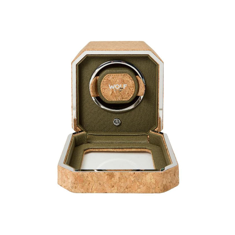 A WOLF Cortica Single Watch Winder box in cork and green sits with its lid open, revealing an empty holder inside.