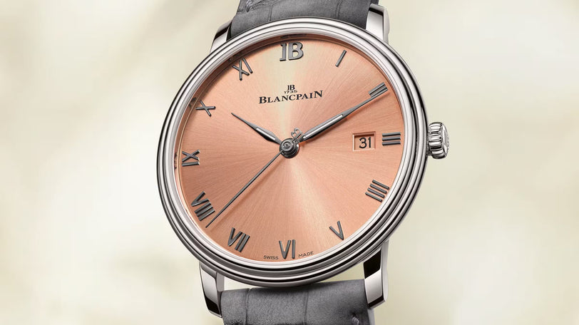 Blancpain Villeret Ultraplate 38mm watch with pink dial, Roman numerals, date window, and gray alligator leather strap.