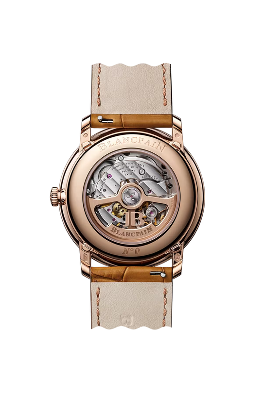 Rose gold round watch with opaline dial, visible movement through caseback, and cream alligator leather strap.