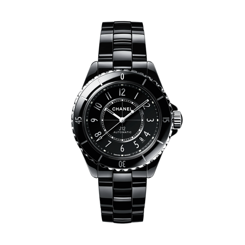 The Chanel J12 is a black automatic watch with a durable ceramic bracelet and round black dial, featuring white hour markers and hands, shown on a plain white background.