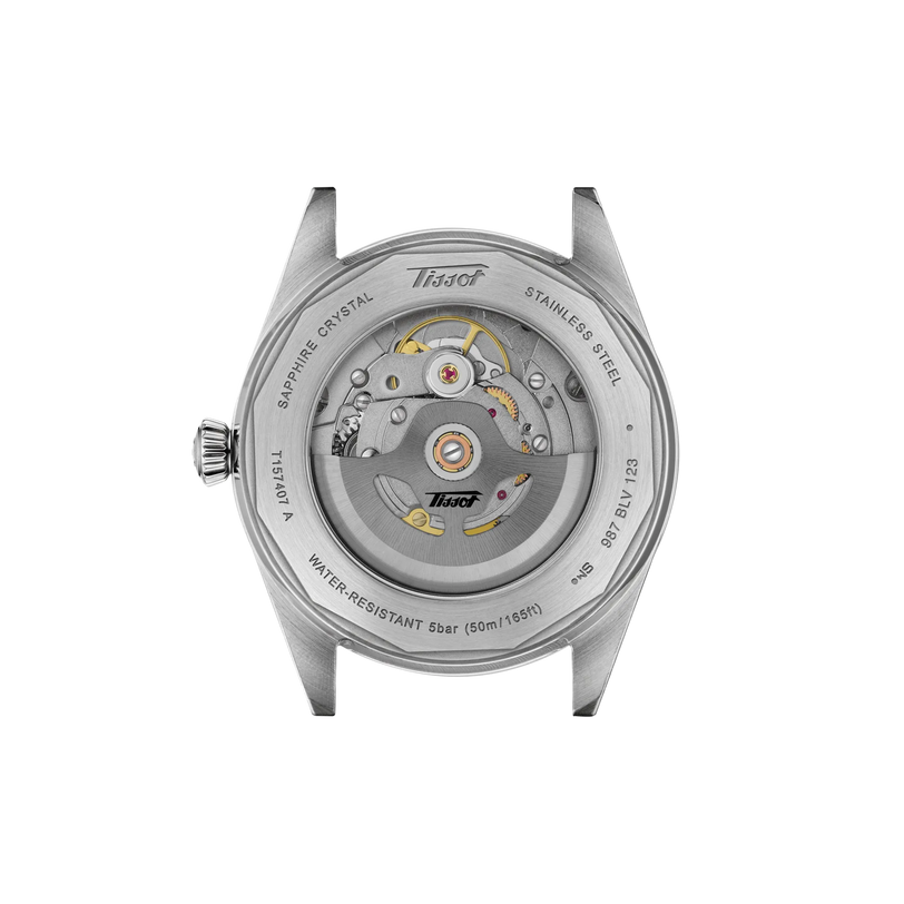 Stainless steel watch case back showing mechanical movement with golden gears and Tissot branding.