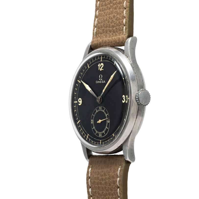 A vintage OMEGA Jumbo Calatrava wristwatch featuring a black dial, tan strap, silver case, and numerals at 12, 3, and 9.