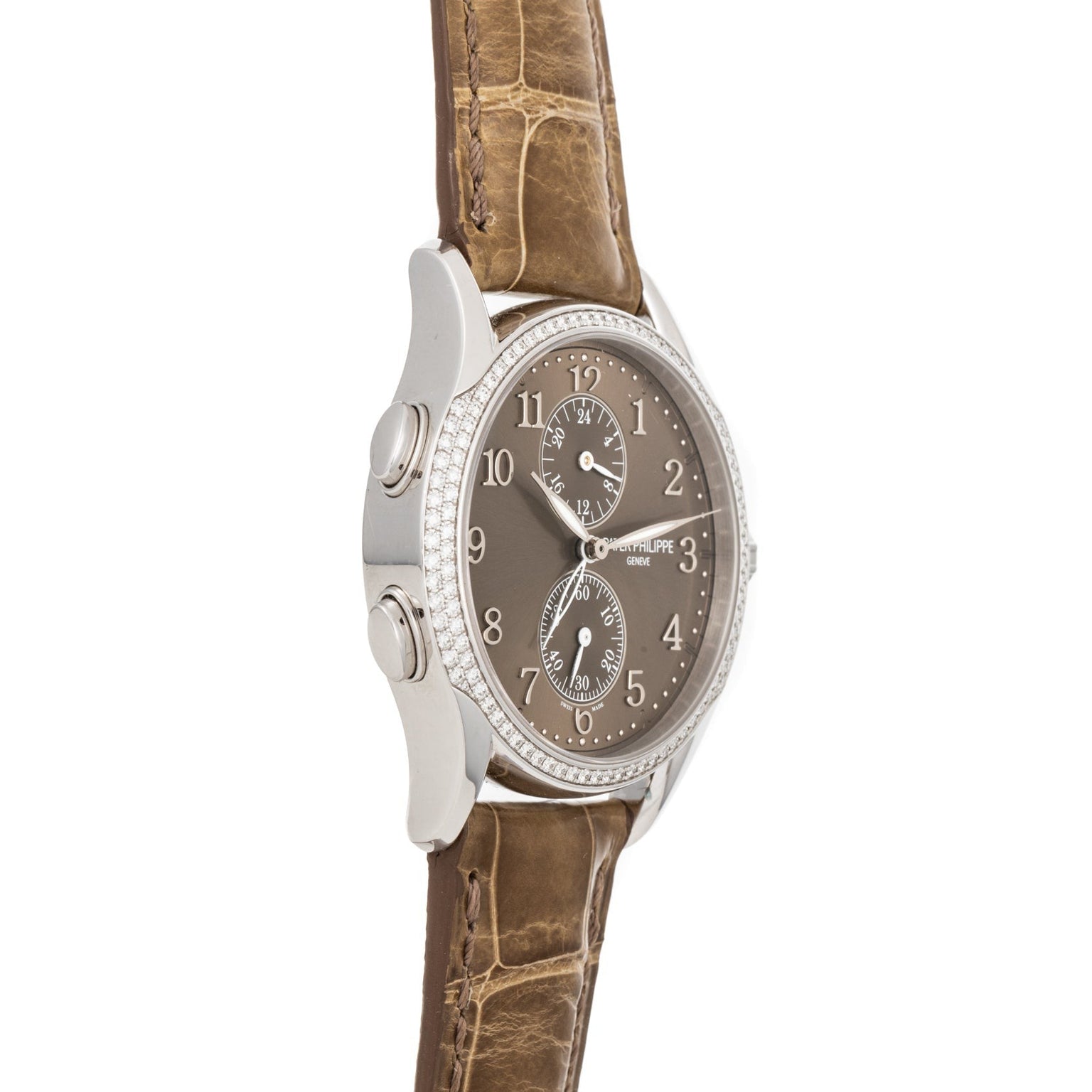 Side view of the Patek Philippe Calatrava Travel Time Ladies watch with a brown leather strap and diamond bezel on a white background.