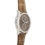 Side view of the Patek Philippe Calatrava Travel Time Ladies watch with a brown leather strap and diamond bezel on a white background.