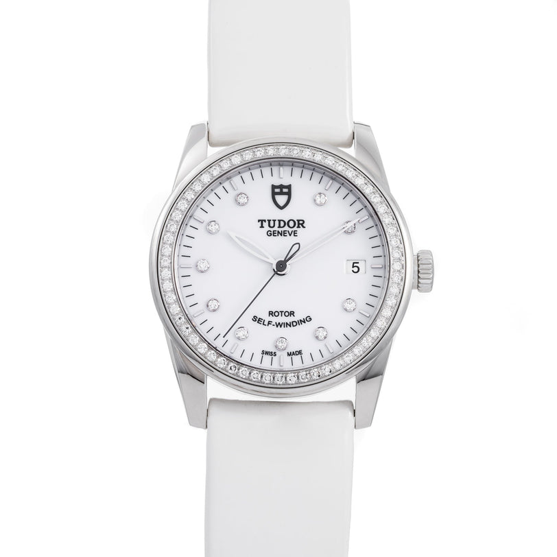 The TUDOR Glamour Date women’s watch features a white strap, diamond hour markers, and a date display at 3 o’clock.