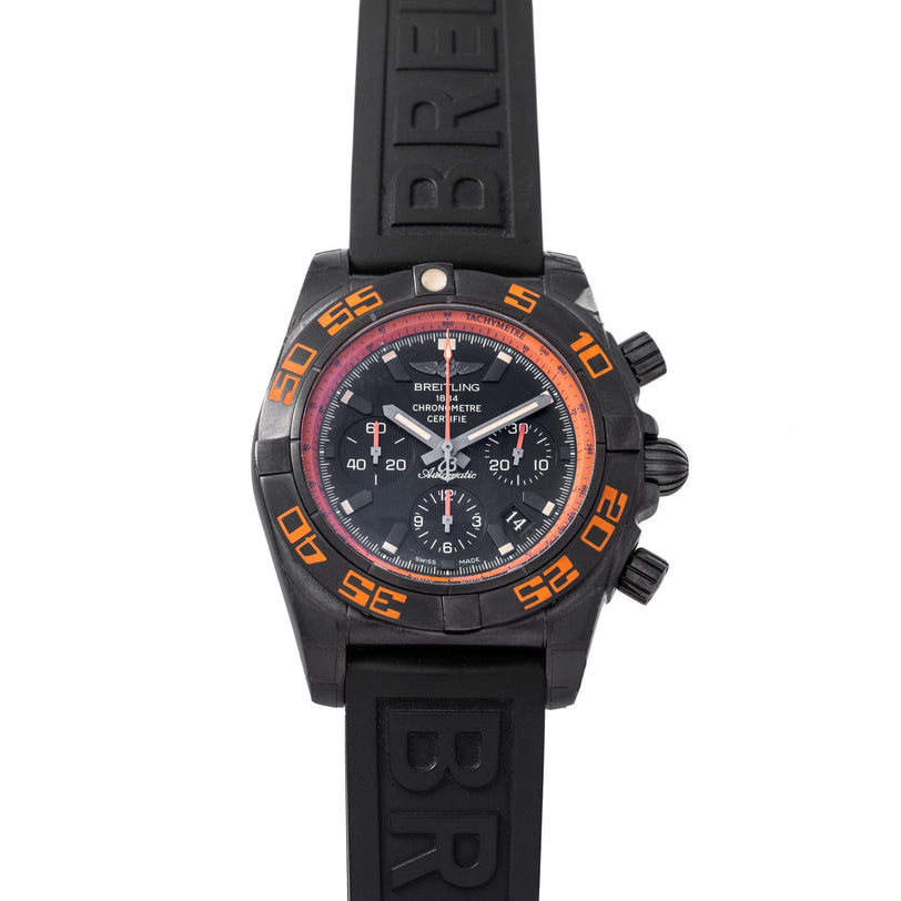 Breitling Chronomat Raven chronograph watch featuring orange accents and a black rubber strap.