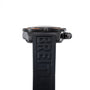 Side view of a Breitling Chronomat Raven wristwatch with a black strap displaying the brand name.