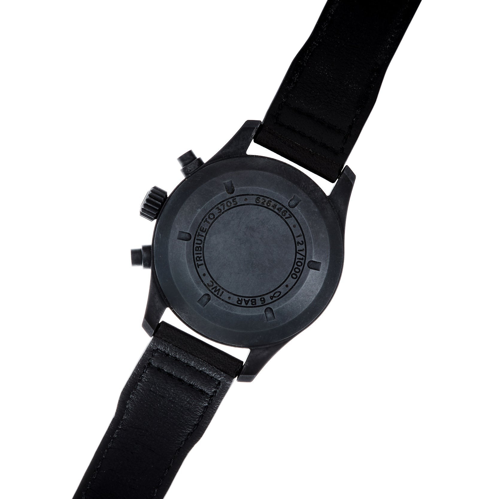 The IWC Schaffhausen Pilots Watch Chronograph Tribute To 3705 is shown from the back, featuring a black leather strap and engraved text on the case.