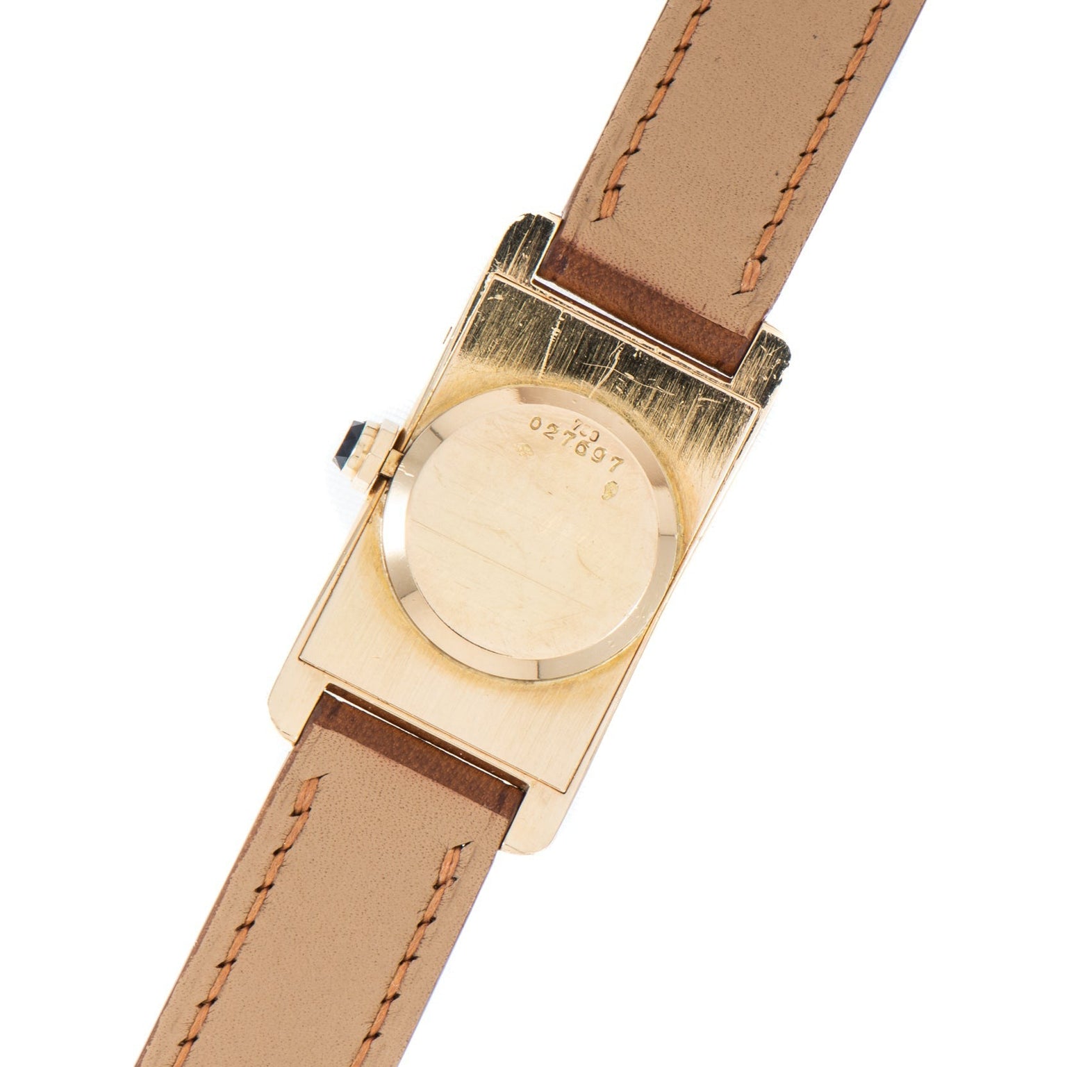 Back view of the Cartier Tank Cintrée Ladies gold watch featuring a brown leather strap and engraved numbers on the case.