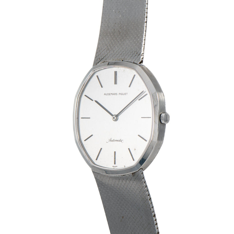 An Audemars Piguet Steel Dress Watch featuring a white face, silver markers, and a mesh metal band.