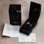 An Audemars Piguet Royal Oak Offshore End of Days luxury watch in a black case, accompanied by its box, certificates, and paperwork.