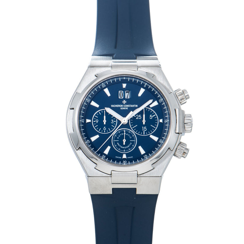 The Vacheron Constantin Overseas Chronograph is a silver watch with a blue face, blue rubber strap, and three subdials.