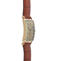 Side view of the Patek Philippe Birks Rectangular Dress Watch in gold with a brown leather strap, shown on a white background.