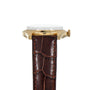 The Patek Philippe Calatrava gold wristwatch with a brown leather strap is shown from the side against a white background.