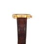 Side view of the Lange & Sohne Lange 1 Timezone gold wristwatch featuring a brown leather strap and visible crown.