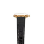 Patek Philippe Calatrava Waterproof gold wristwatch with a round face and black leather strap, shown from the side against a white background.