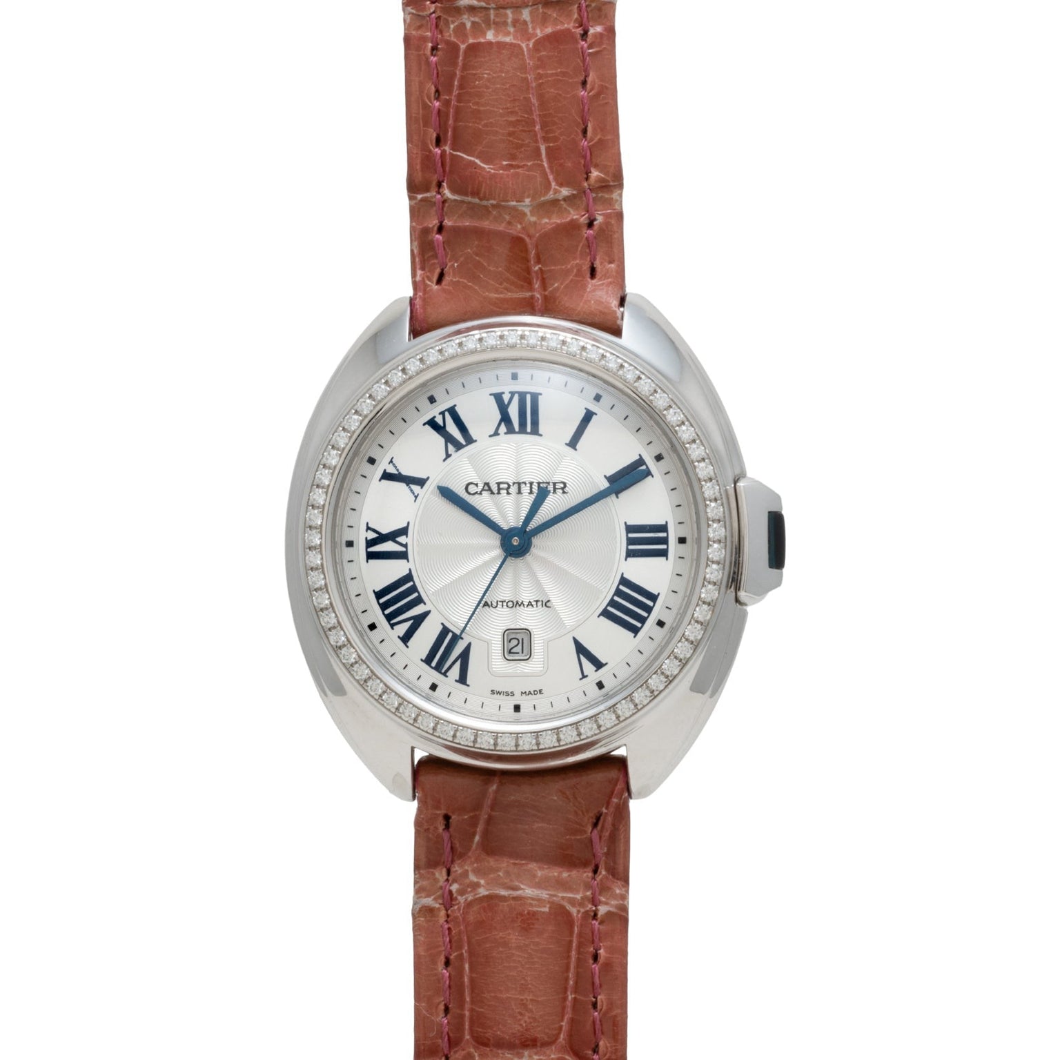 The Cartier Cle de Diamond watch features a brown leather strap, silver case, Roman numerals, and a date window at 6 o’clock.