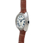 The Cartier Clé de Diamond watch features a silver case, brown leather strap, and Roman numerals on the dial, seen from an angled perspective.