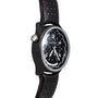 The Jaeger-LeCoultre Amvox 5 World Chronograph wristwatch, by Jaeger-LeCoultre, features a detailed dial, black perforated band with red stitching, and is displayed at an angle.