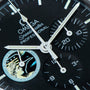 Close-up of the OMEGA Speedmaster Professional Missions Apollo XVII watch face featuring the Apollo mission emblem detail.