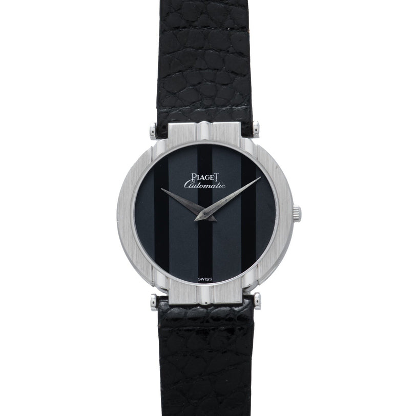 A Piaget White Gold Ladies wristwatch featuring a black striped dial and a black textured leather strap.