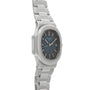 The Patek Philippe Nautilus, a silver metal wristwatch with a blue dial, date display, and linked bracelet, is shown at an angle.