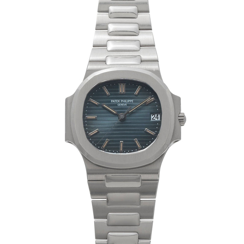 The Patek Philippe Nautilus features a blue dial with date display and is presented on a silver metal bracelet.