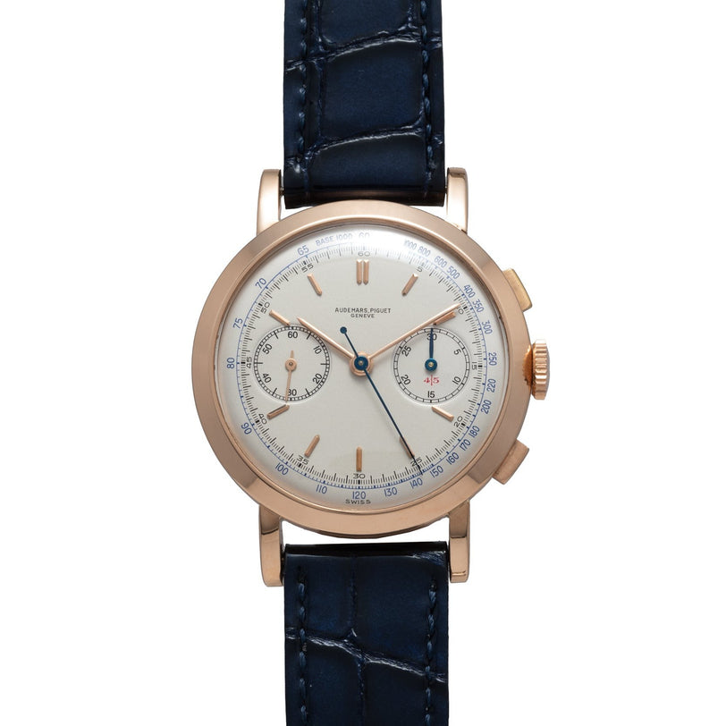Audemars Piguet Jumbo Two-Register Chronograph with a gold case, white dial, blue hands, and dark blue leather strap, shown on a white background.