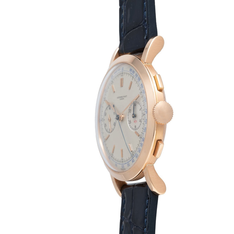 Side view of the Audemars Piguet Jumbo Two-Register Chronograph featuring a gold case, white dial, blue leather strap, and two chronograph subdials.