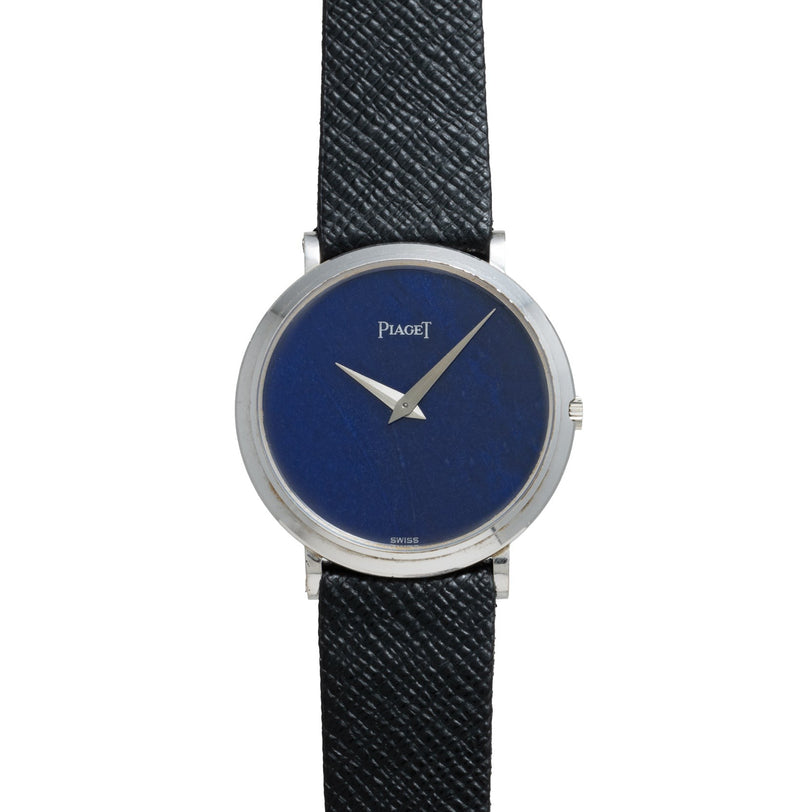 The Piaget Ladies Lapis Lazuli Dress Watch features a blue lapis lazuli face, silver case, and a black textured leather strap, displaying the time 3:40.