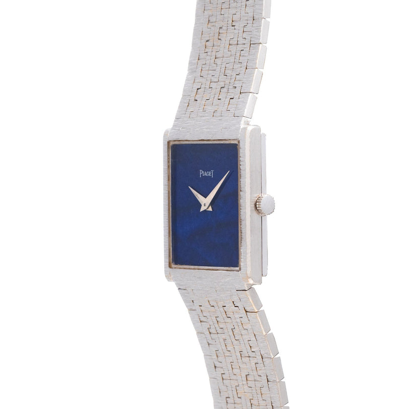 Piaget White Gold Lapis Lazuli Dress Watch with a blue lapis face, rectangular case, and textured white gold band, displaying the time at 10:10.