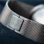 Close-up of the White Gold Lapis by Piaget, a Cartier watch featuring a silver mesh metal band with clasp, set against a dark background.