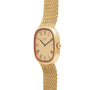 Patek Philippe Ellipse TV Case watch with a gold mesh band, rectangular face, Roman numerals, and date window.