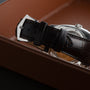 Close-up of the Patek Philippe Gondolo Annual Calendars brown leather strap with a silver buckle, resting in a brown box.