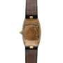 Back view of the Cartier Baignoire Allongee wristwatch in gold with a brown leather strap and diamond-set case edges.