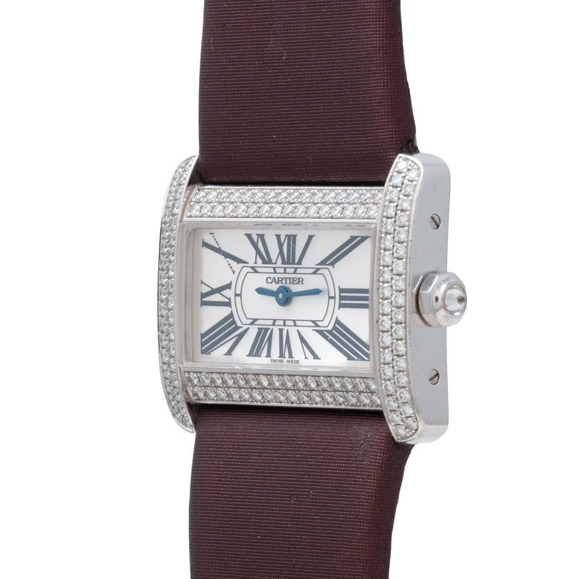 Cartier Tank Divan watch featuring a diamond bezel, Roman numerals, and brown strap, shown from an angled view.