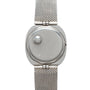 The Patek Philippe Dress Watch UFO features a silver mesh band and a smooth, blank face with no numbers or hands.