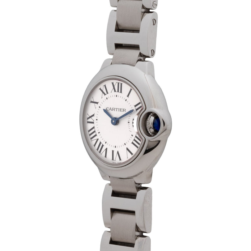 The Cartier Ballon Bleu wristwatch features Roman numerals and a metal link band, displayed at an angle.