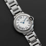The Ballon Bleu by Cartier is a silver wristwatch featuring Roman numerals on a black leather strap.