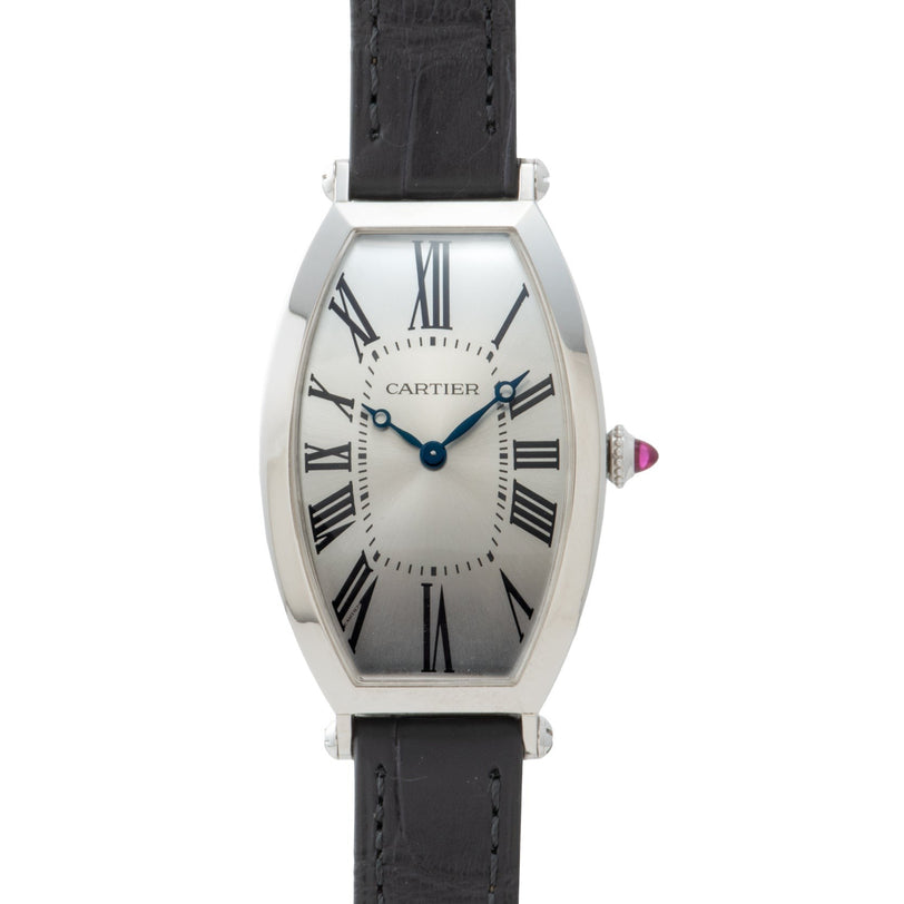The Cartier Tonneau Platinum wristwatch features Roman numerals, blue hands, and a black leather strap.