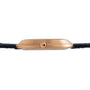 Side view of the Piaget Black Tie Andy Warhol gold case wristwatch with a black leather strap, highlighting the crown and ribbed detailing.