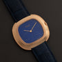 Piaget Black Tie Andy Warhol wristwatch featuring a blue speckled face and dark blue leather strap, displayed on a black surface.