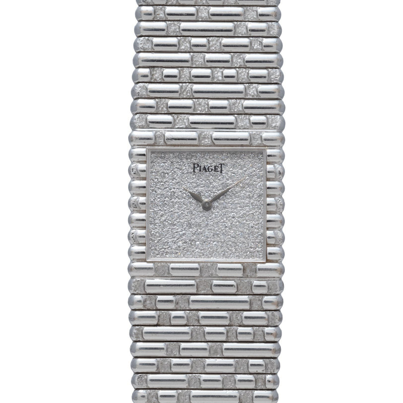 A Piaget Emperador Diamond wristwatch featuring a silver-tone textured square face and a brick-patterned metal band.