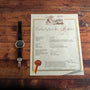 A Patek Philippe Perpetual Calendar Moonphase with a black leather strap rests beside a certificate titled Extract from the Archives.