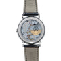 A close-up of the Patek Philippe Perpetual Calendar Moonphase watchs back, highlighting its intricate mechanical movements and leather strap.