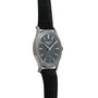 The Patek Philippe Calatrava, a luxury wristwatch with a black leather strap and dark dial, shown from an angle.