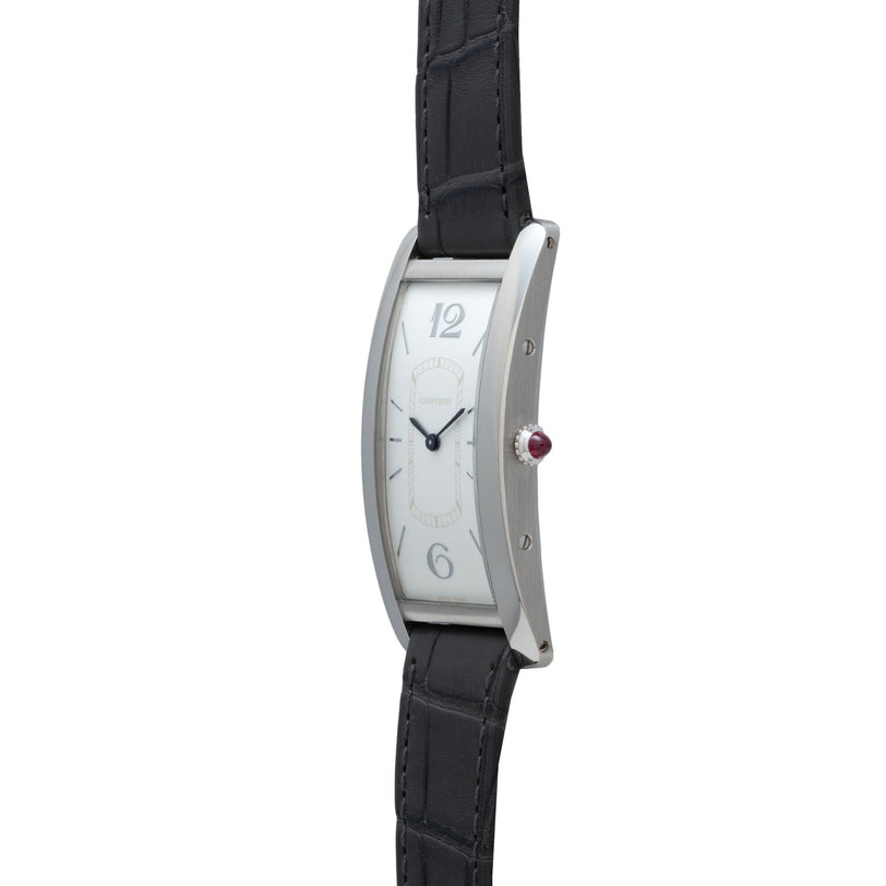 The Cartier Tank Cintrée Limited Edition is a silver rectangular wristwatch featuring a black leather strap, white face, and minimal hour markers.